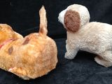 two stuffed animals sitting next to each other on a black background