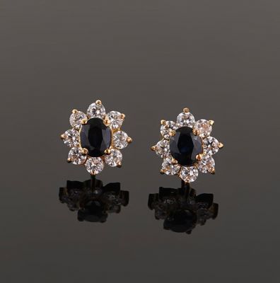 a pair of sapphire and diamond earrings