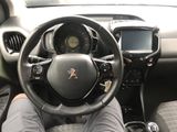 someone is sitting in the driver ' s seat of a car with their feet on the steering wheel