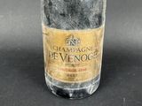 bottle of champagne sitting on a table with a black background
