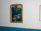 two mirrors hanging on the wall above a bed