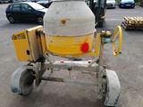 a cement mixer that is sitting in the parking lot