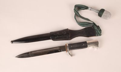 two different types of knives on a white surface