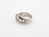 silver ring with pearls on a white background