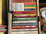 a lot of books that are stacked on top of each other