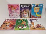 cinq livres pour enfants sont alignés sur une surface blanche