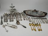 a lot of silverware and silverware on the table