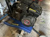 an image of a small lawn mower in a garage
