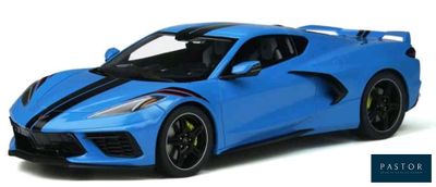 the blue sports car is parked on a white surface