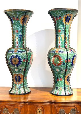 two vases that are sitting on top of a dresser