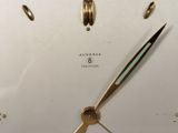 a close up of a clock that is on a table