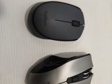 two computer mouses sitting on a table next to each other