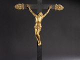 a gold and black crucif with a cross on a black background