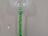 a green wine glass sitting on top of a table