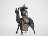 statue of a woman riding a horse with a hat on her head