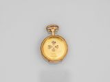 a close up of a gold pocket watch on a white surface