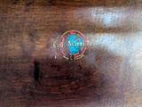 a close up of a wooden table with a logo on it