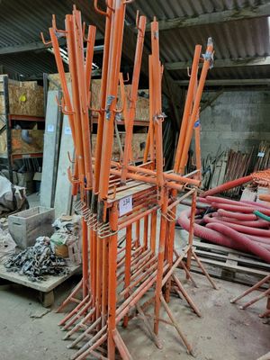 a large pile of orange pipes sitting in a warehouse