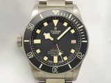 the watch has a black dial and yellow numbers on the face