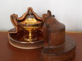 un petit objet métallique posé sur une table à côté d'un bougeoir