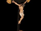 statue of jesus on the cross with two pom poms