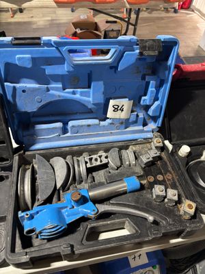 a blue tool box with tools in it on a table