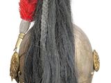 a close up of a helmet with a red mohawk on it