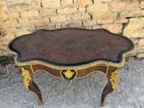 a small table that has a red and gold decoration on it