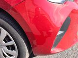 a close up of a red car with a black stripe on it
