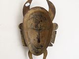 a close up of a metal object on a white wall