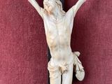 a statue of jesus on the cross with a banner on it