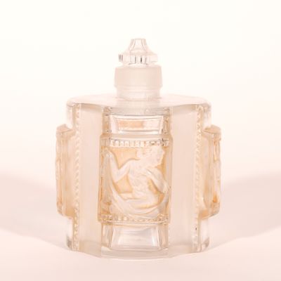 une bouteille en verre transparent sur laquelle est représentée une femme