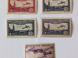four different stamps from different countries on a white surface