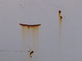 a rusted sign on the side of a white truck