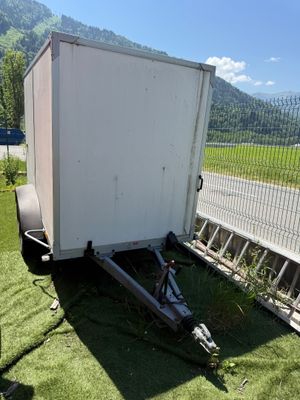 une remorque garée sur l'herbe au bord de la route