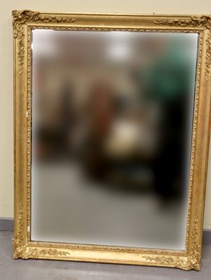 a mirror that is sitting on the floor in front of a wall