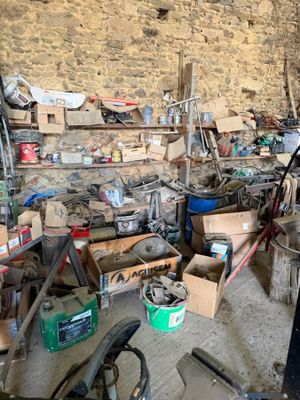 a room filled with lots of tools and a brick wall