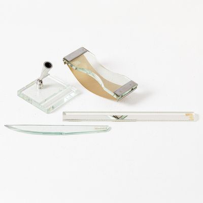 a glass and metal object on a white surface