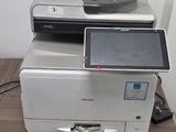 a printer sitting on top of a desk next to a computer