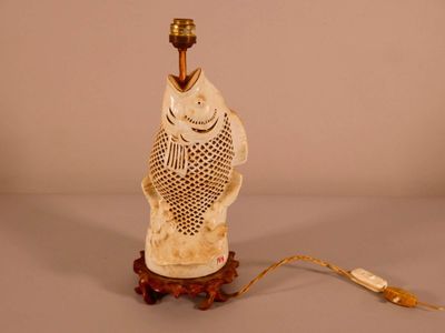 a lamp that has a fish on it on a table
