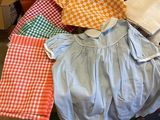 a suitcase full of baby clothes and other items on the floor