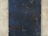 an old blue book sitting on top of a cement floor