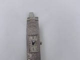 a close up of a wrist watch on a white surface