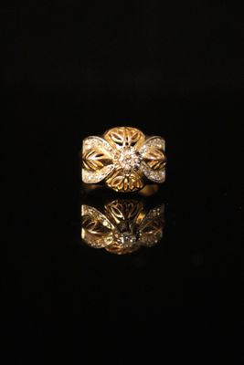 an image of a gold ring on a black surface