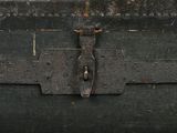 a black trunk with a metal latch on it