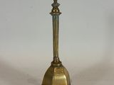 brass plated candle holder on a white surface with a white background