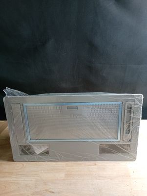 un micro-ondes posé sur une table recouverte d'un film plastique