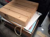 a wooden box that is sitting on top of a suitcase