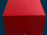 a red box with a lizard on it sitting on a table