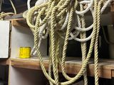 a lot of rope hanging from the ceiling of a garage